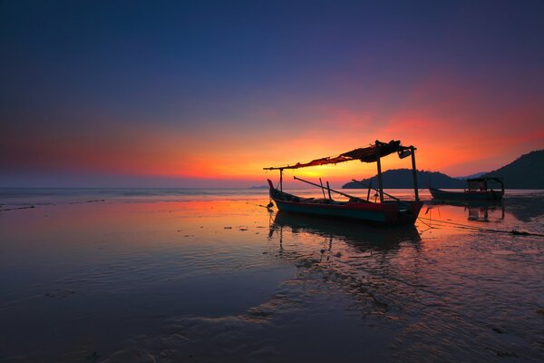 Amanecer en el mar con un barco roto