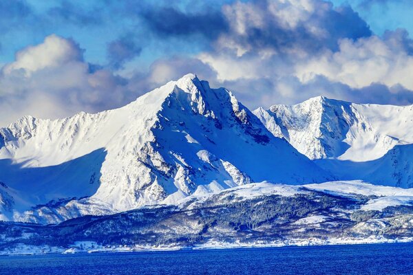 A bright day in the snow-capped peaks of the mountains. Panoramic mountains in Norway