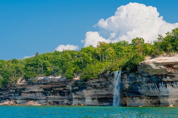 Waterfall with chips with dense forest