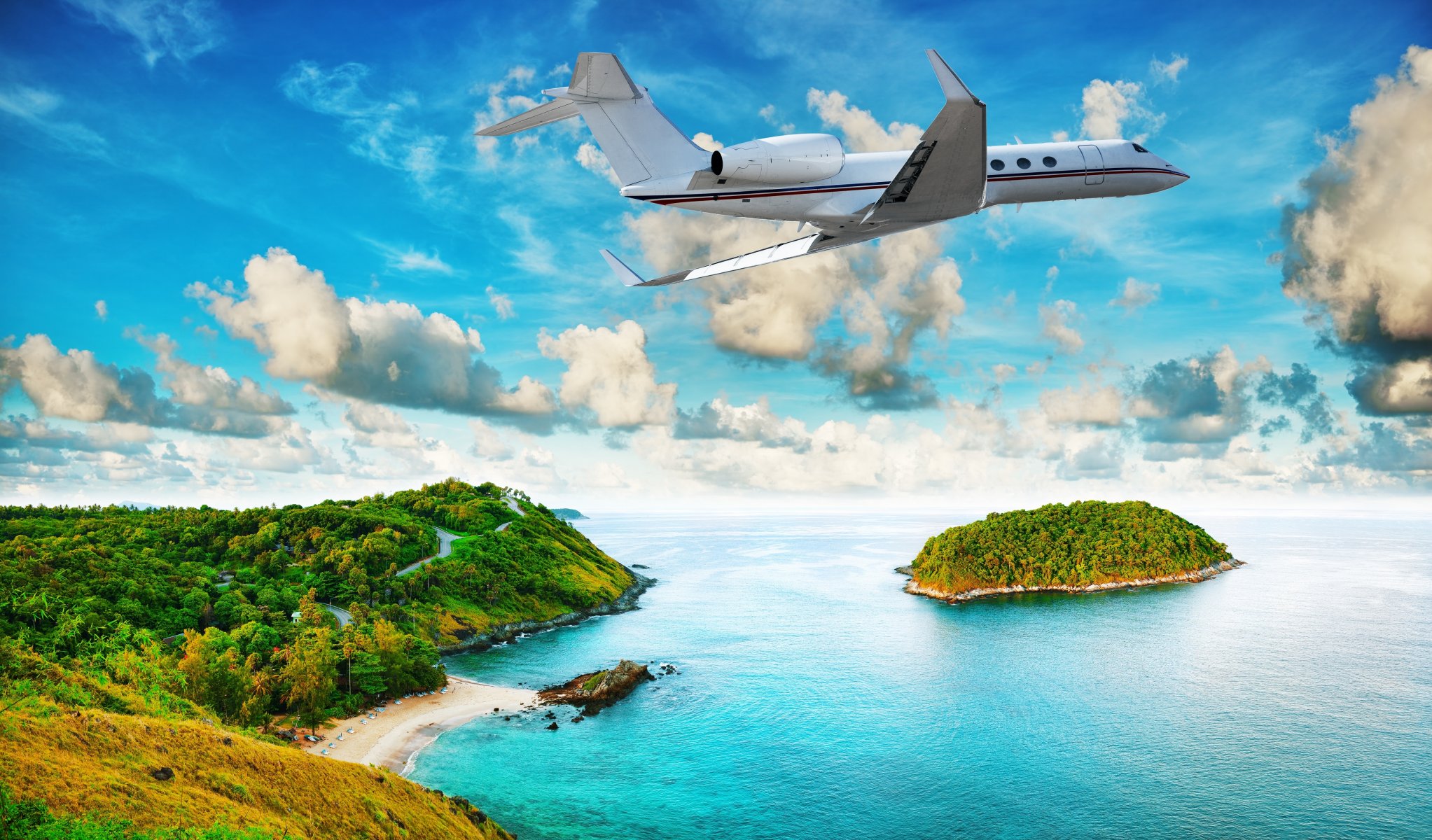 plane flying over the island tropics beach sea