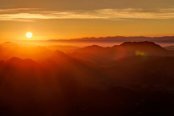 Dawn mountains sun rays