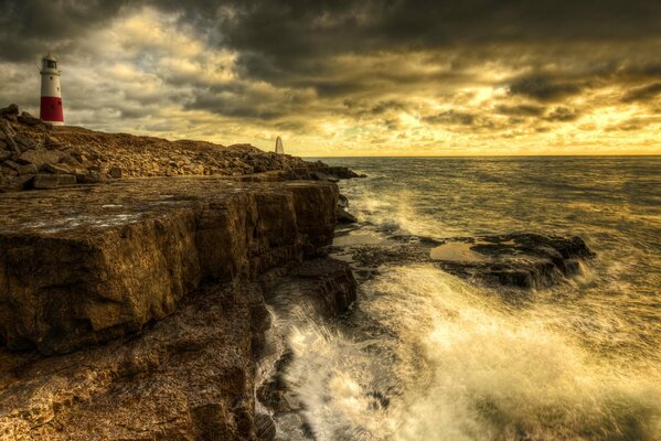 Ocean, evening lighthouse rocky shore