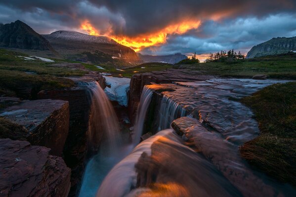 Cascade of waterfalls on the background of the sunset sky