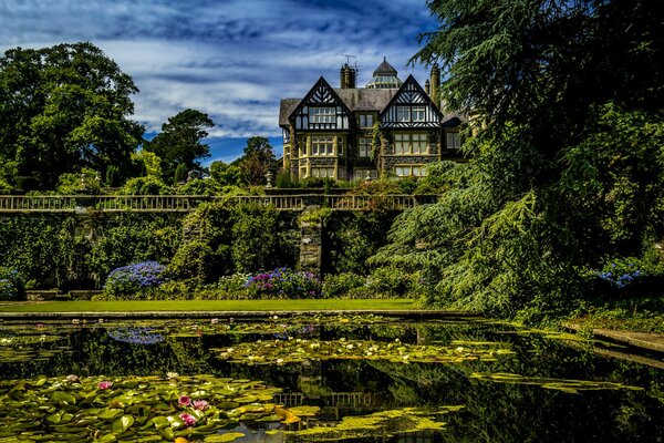 A house with a garden near a pond in Wales