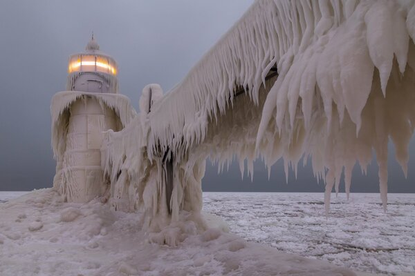 Winter lighthouse with huge ice floes