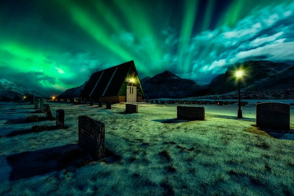 Northern lights at night on the background of the cemetery