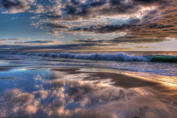 The breath of the ocean on the background of sunset