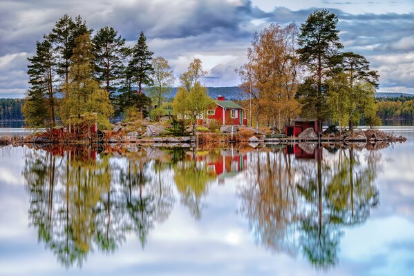 Autumn lake with a house