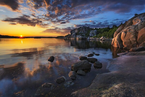 The coast is close to rocks, rocks and sunset