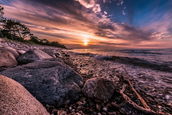 The beauty of Denmark, hornbaek, the quiet surf gently brings the well-aimed stones to the shore