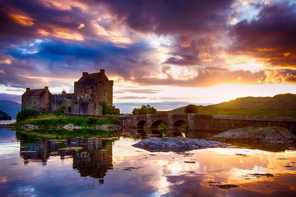 Scottish castle in the reflection of the lake