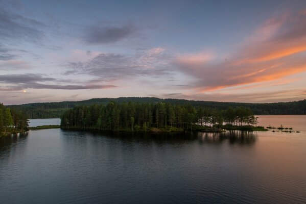 Sunset over the island of a clear lake