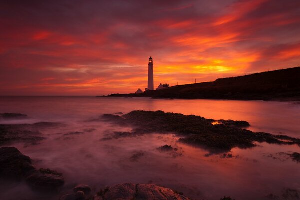 Plage sur fond de phare debout au loin