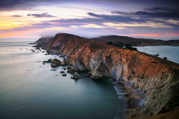 Endless ocean and rocks at sunset