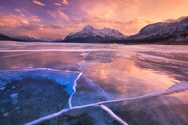 Lake covered with ice at sunset