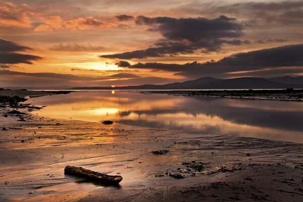 A shallow lake on the background of sunset