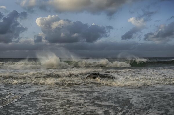 Storm waves under a beautiful sky