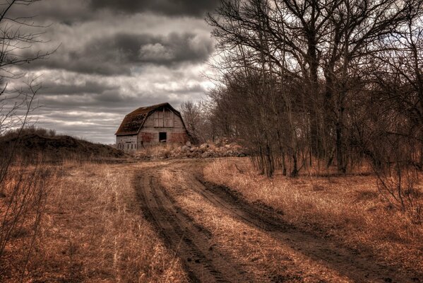 An autumn cloudy day. Abandoned barn