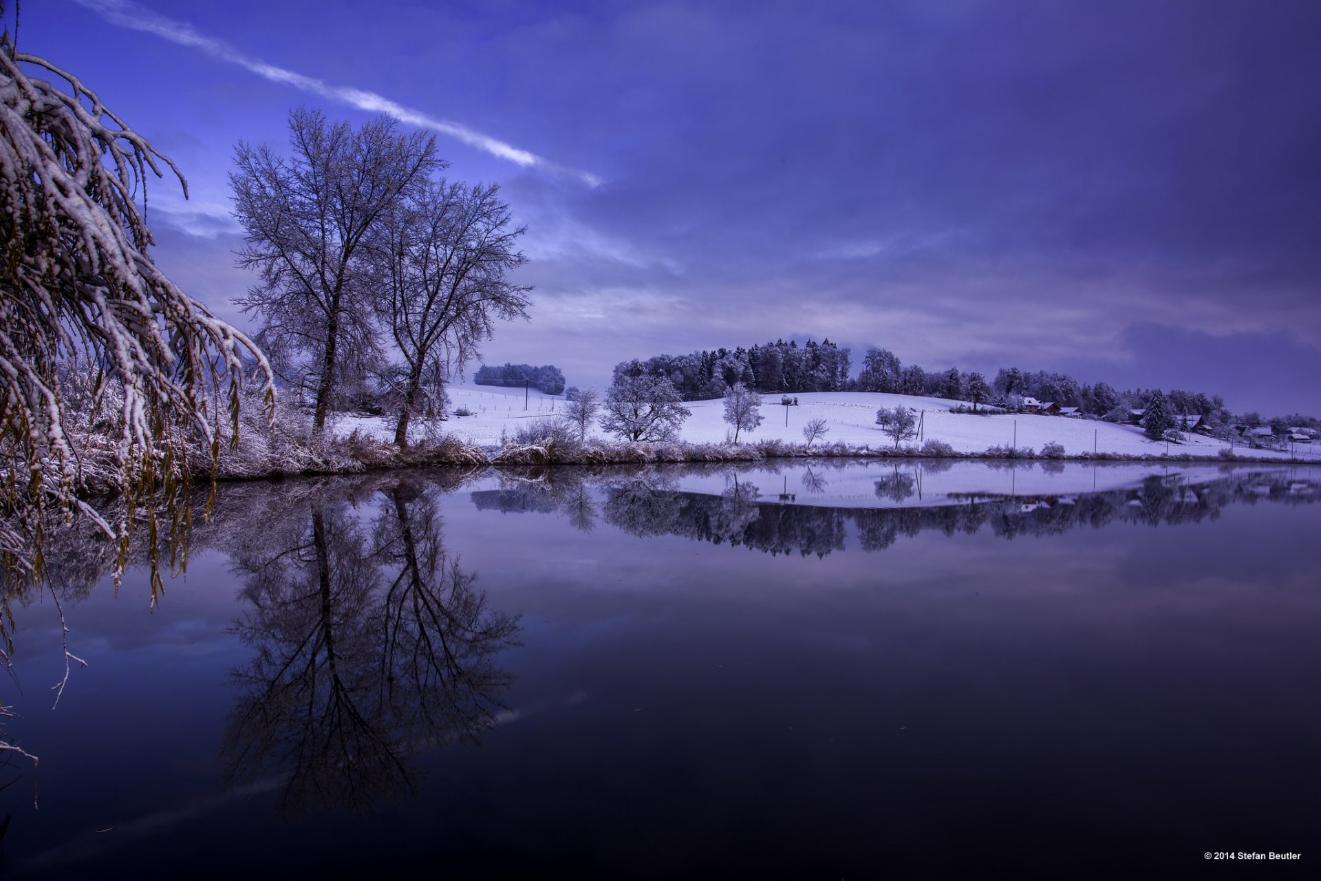 winter snow tree hills river water surface of blue sky reflection