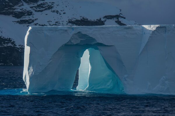 An arch in an iceberg among the northern waters