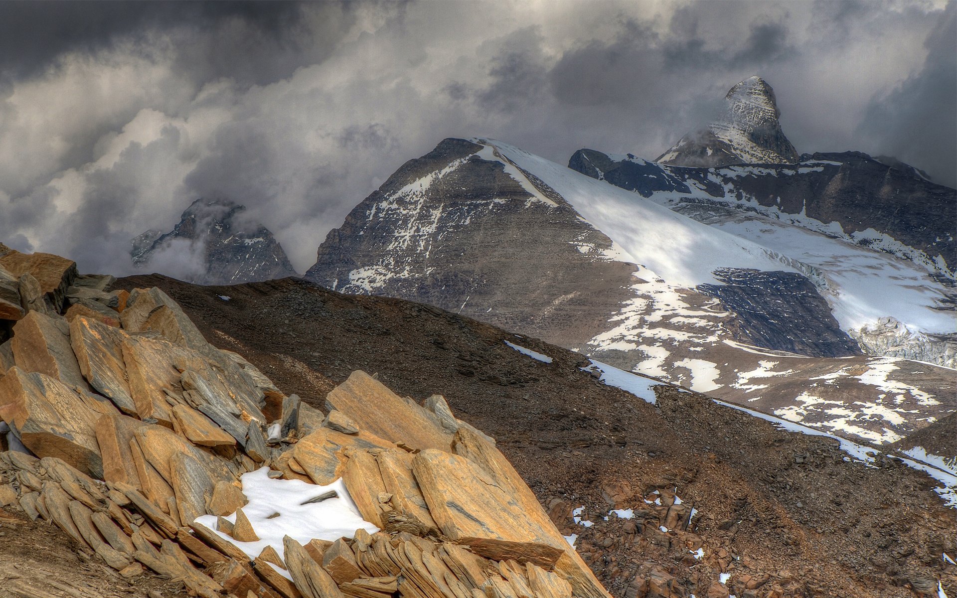 mountain rock stones snow clouds rain