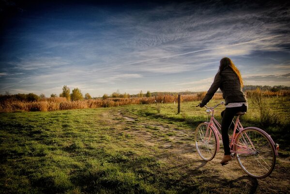 A girl rides a bicycle