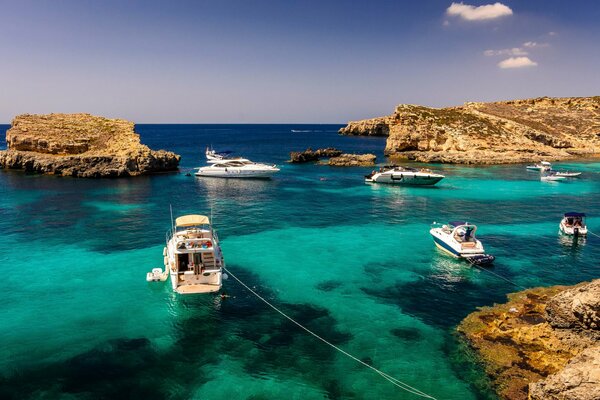 Yachts in the ocean among the Maltese rocks