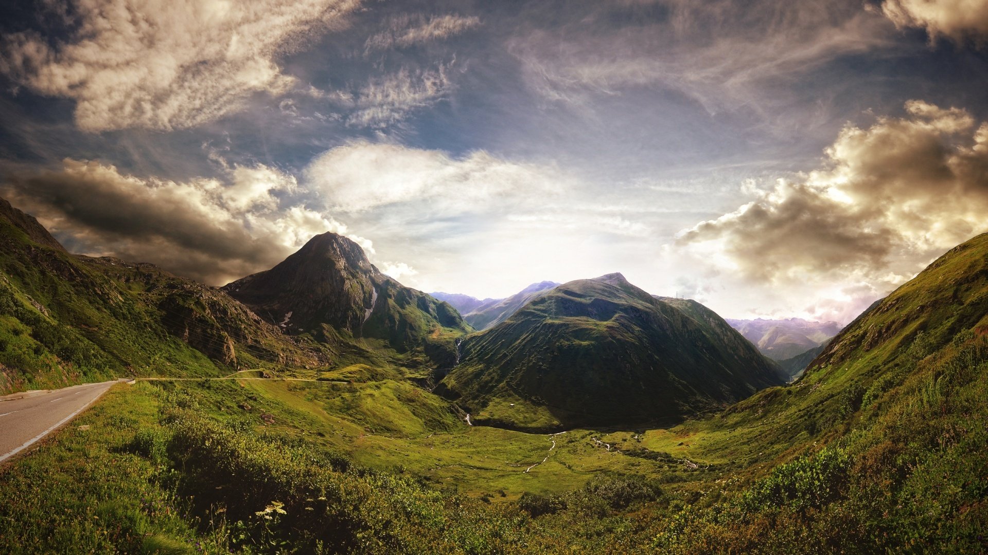 road mountain switzerland green sky