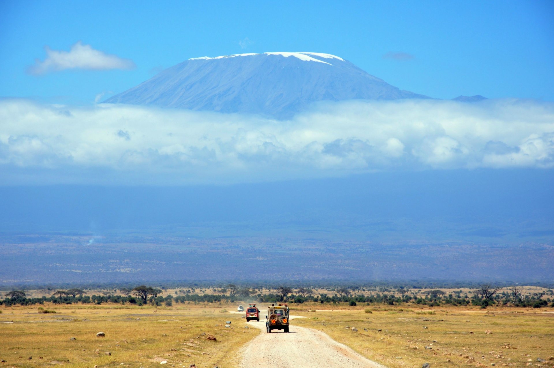 landscape africa road vehicles mountain sky clouds savannah safari sports vacation