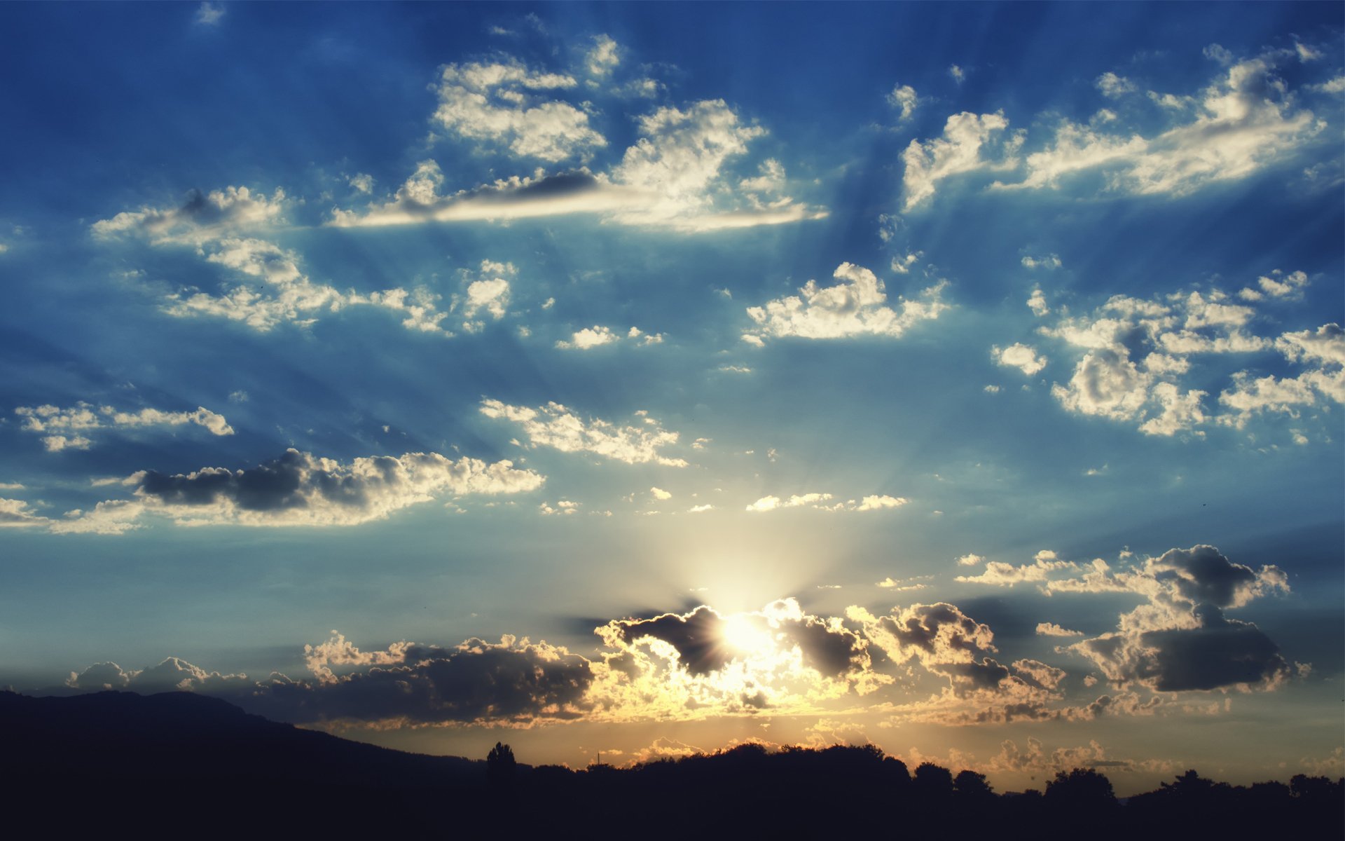 unset sky clouds hills silhouette