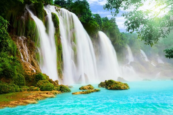 A beautiful waterfall flows into the blue lake