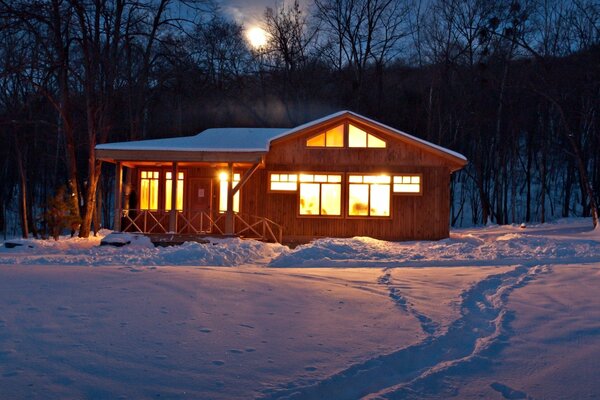 Maison chaude dans la forêt d hiver. Soirée tranquille dans les bois