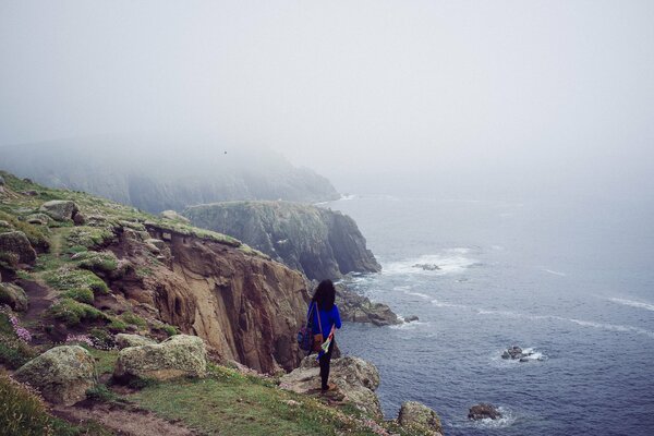 A girl standing on the edge of a cliff