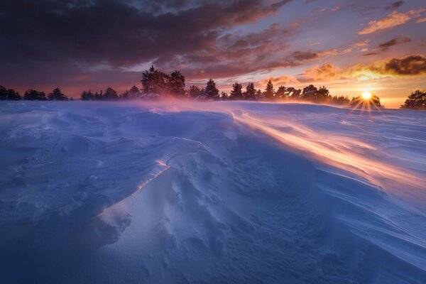 The sun shines on snowdrifts