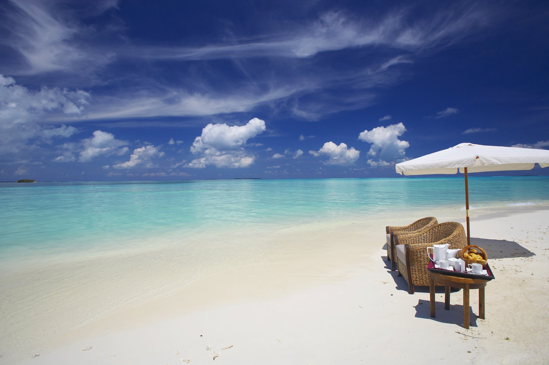 the maldives ocean beach sand water clouds umbrella