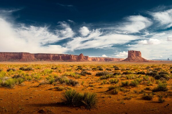 Desert landscape on the background of rocks and bottomless sky