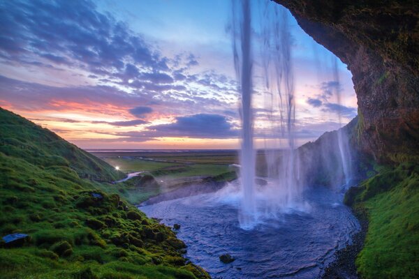 Waterfall from the rock at sunset