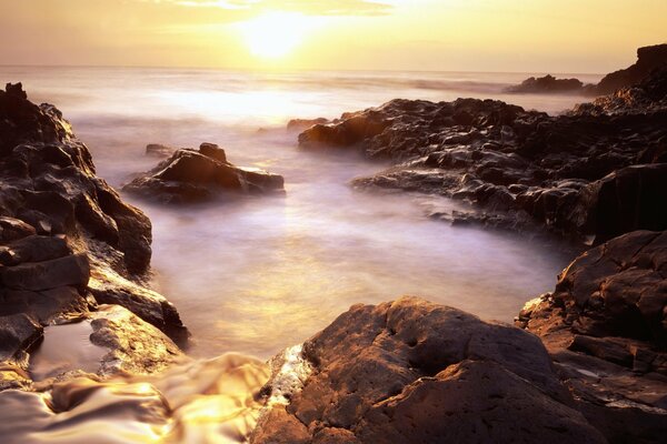 Beautiful photo of the sunrise among the rocks in the fog