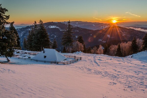 Matin neigeux dans les montagnes. maison dans les montagnes