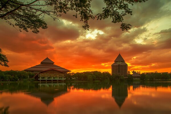 The orange sky is reflected in the river