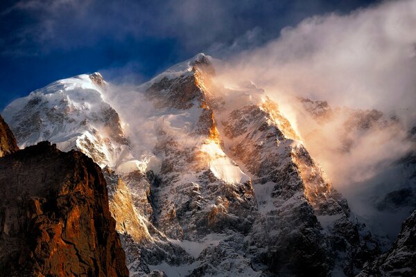 Snowy mountains on which the sunlight shines