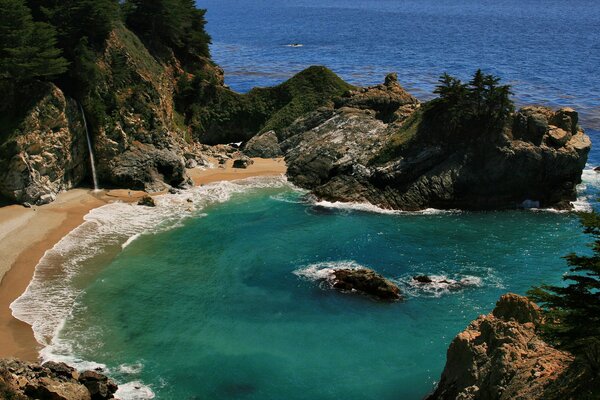 A bay in the ocean with a sandy beach