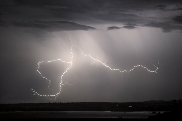 Huge lightning cuts through the dark sky