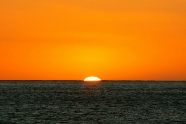 Orange sunset, sea and sky horizon line