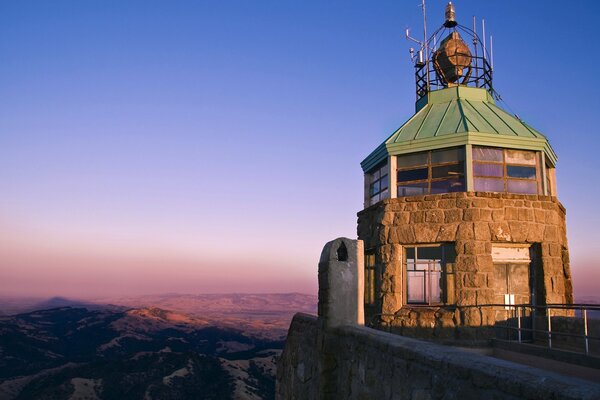 The old tower on the background of the lilac sky