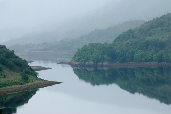 The river in the morning mist among the hills