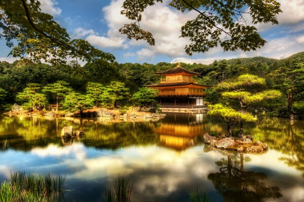 By the lake, a Chinese-style house among baobabs