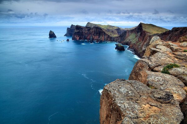 Charming cliffs of Portugal on the background of the ocean