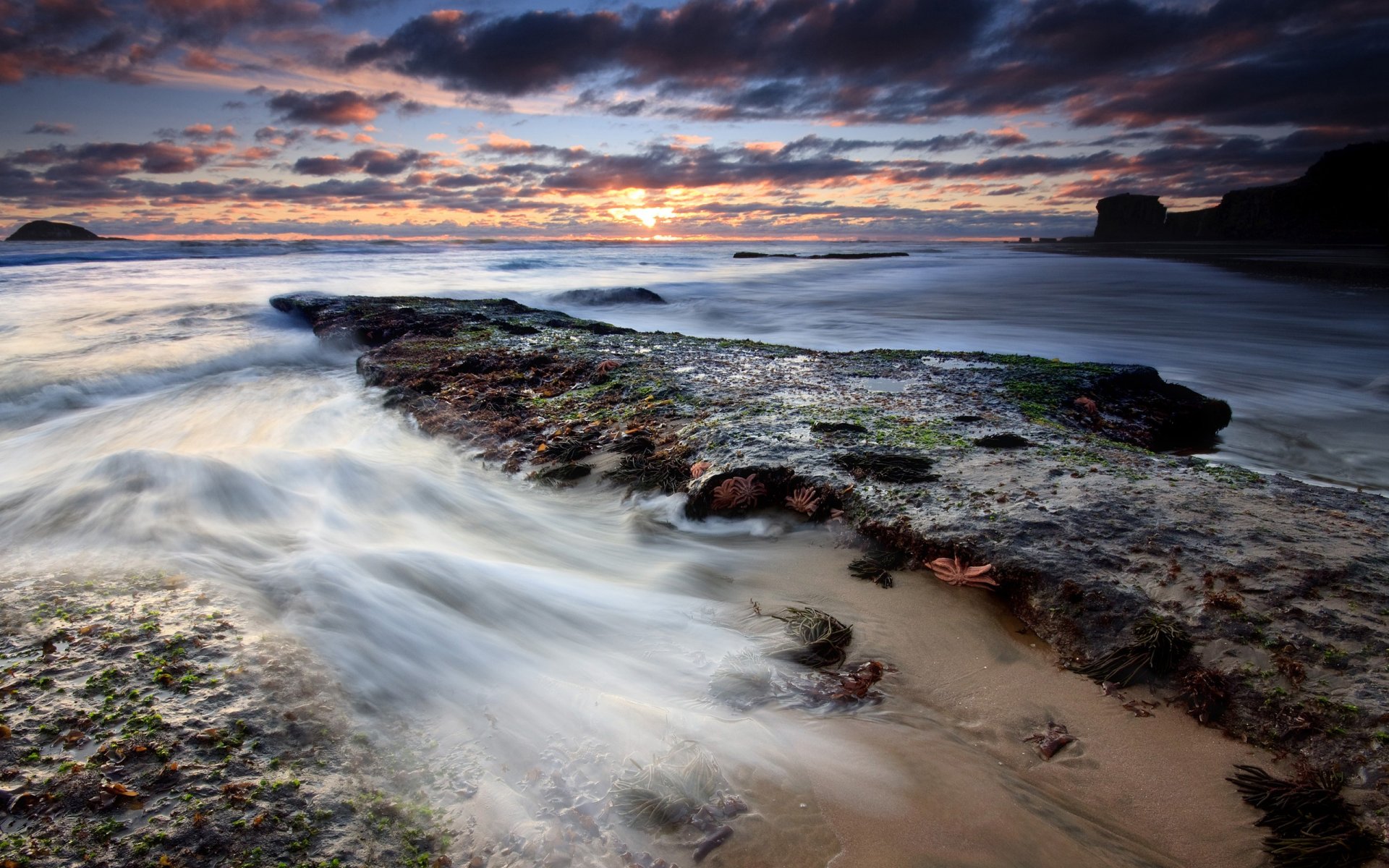 beach stones water clouds tide