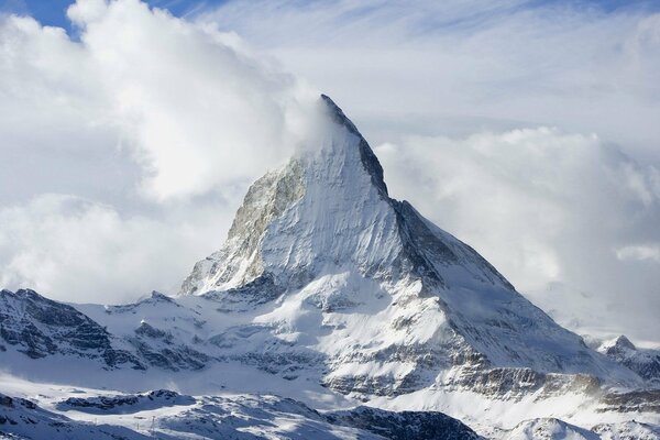 A snow-capped mountain peak in the clouds